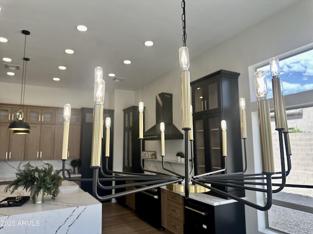 kitchen featuring recessed lighting, dark wood-style flooring, decorative light fixtures, glass insert cabinets, and light stone countertops