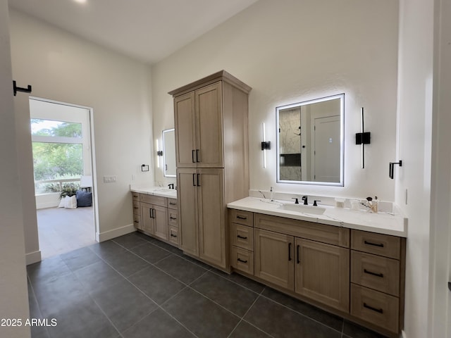 full bathroom with two vanities, tile patterned flooring, and baseboards