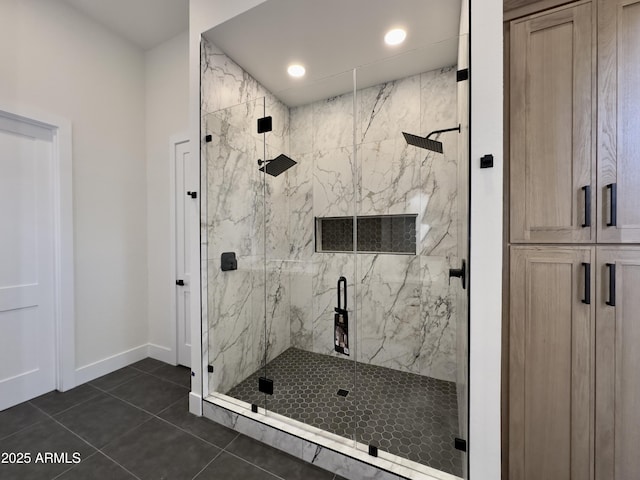 bathroom featuring a marble finish shower, tile patterned flooring, baseboards, and recessed lighting