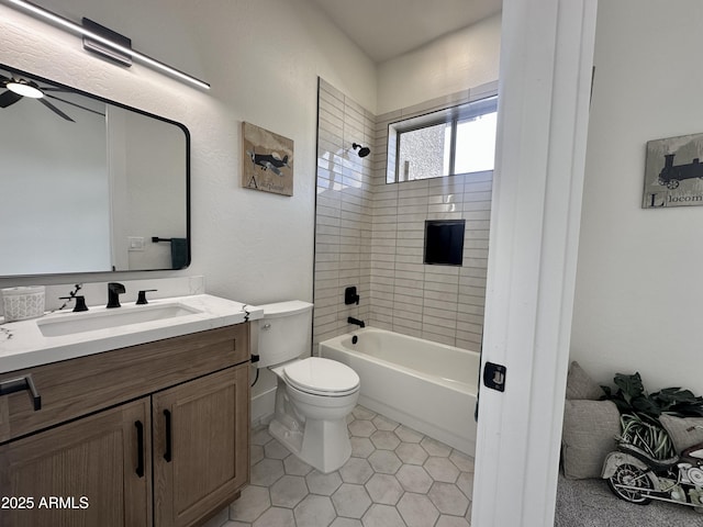 bathroom with toilet, vanity, tile patterned flooring, tub / shower combination, and a ceiling fan