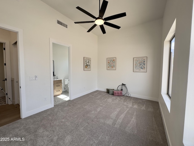 unfurnished bedroom with carpet flooring, baseboards, and connected bathroom