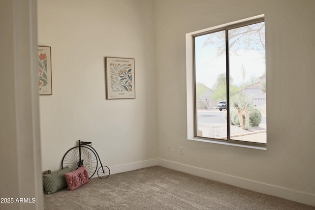 carpeted spare room with baseboards