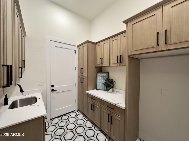 clothes washing area with a sink