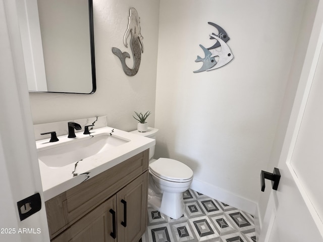 bathroom featuring vanity, toilet, and tile patterned floors