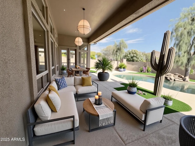 view of patio featuring an outdoor hangout area, a fenced backyard, and french doors