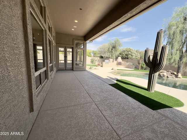view of patio with french doors and a fenced backyard