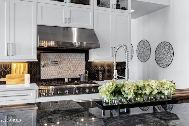 12228 E Wood Dr, Chandler, AZ 85249 - kitchen with dark stone countertops, under cabinet range hood, and white cabinets