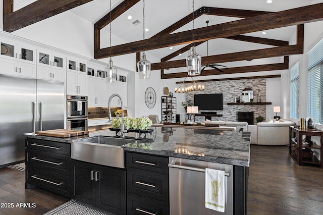 12228 E Wood Dr, Chandler, AZ 85249 - kitchen with a sink, stainless steel appliances, dark cabinetry, dark wood-style floors, and beam ceiling