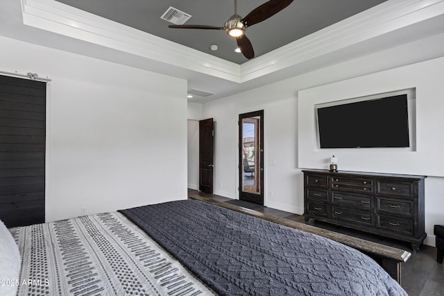 12228 E Wood Dr, Chandler, AZ 85249 - bedroom with visible vents, baseboards, a ceiling fan, a tray ceiling, and wood finished floors