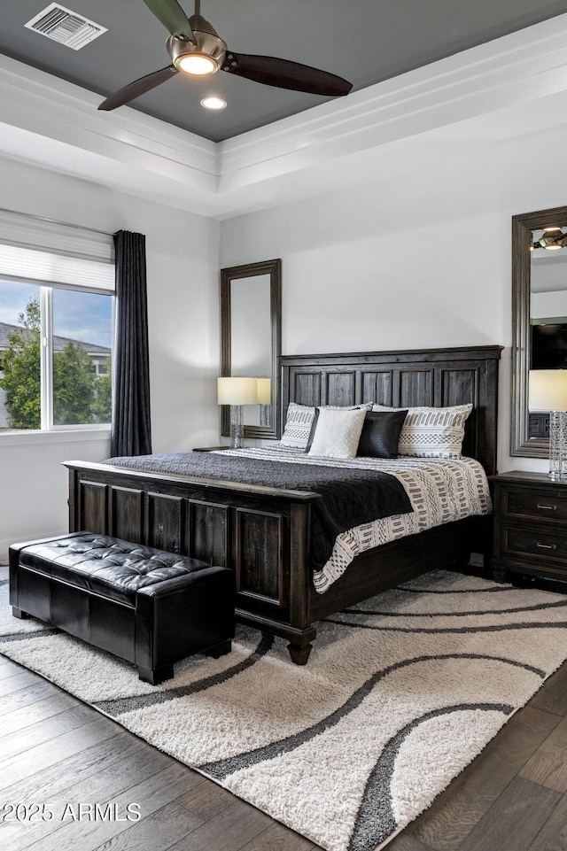 12228 E Wood Dr, Chandler, AZ 85249 - bedroom with a raised ceiling, a ceiling fan, visible vents, and hardwood / wood-style flooring
