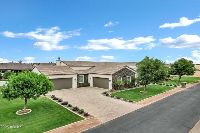 12228 E Wood Dr, Chandler, AZ 85249 - view of front of house featuring stucco siding, decorative driveway, stone siding, a front lawn, and a garage