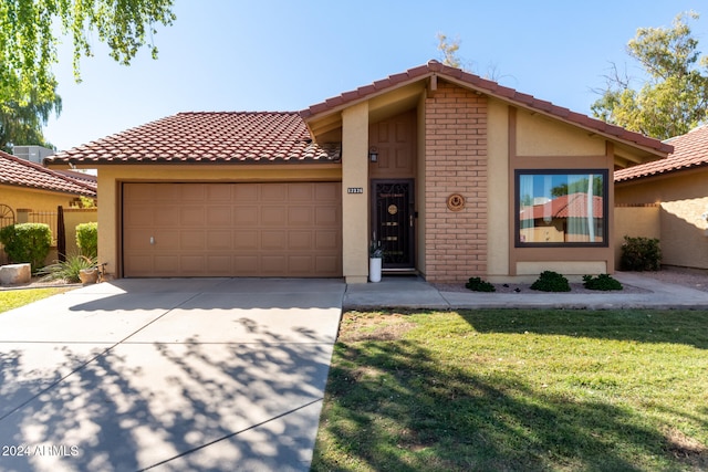 view of front of property with a front lawn and a garage