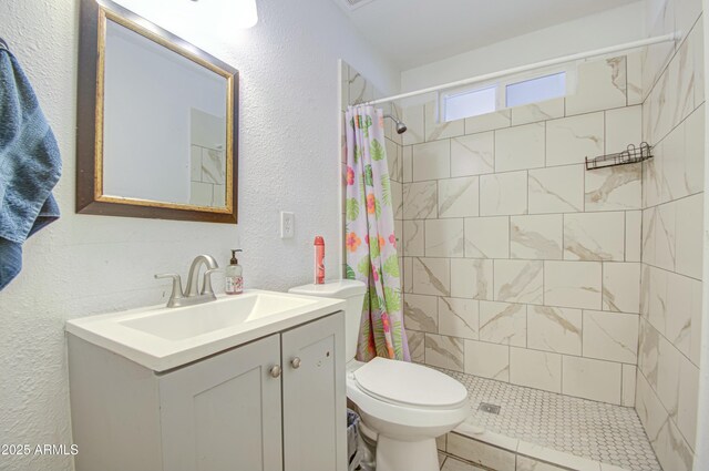 2022 W Atlanta Ave, Phoenix, AZ 85041 - full bathroom with a textured wall, toilet, vanity, and a tile shower