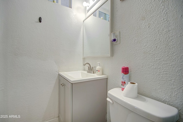 2022 W Atlanta Ave, Phoenix, AZ 85041 - bathroom featuring toilet, vanity, and a textured wall
