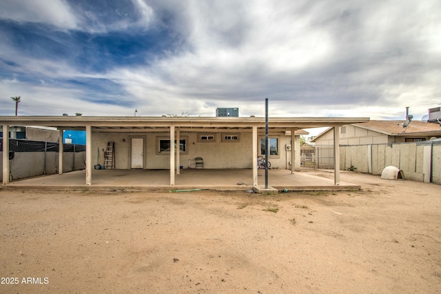 2022 W Atlanta Ave, Phoenix, AZ 85041 - back of property with stucco siding, central AC, a patio, and fence