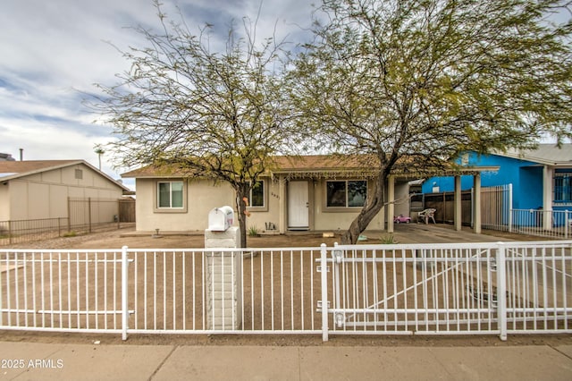 2022 W Atlanta Ave, Phoenix, AZ 85041 - view of front of home with a gate, a fenced front yard, and stucco siding