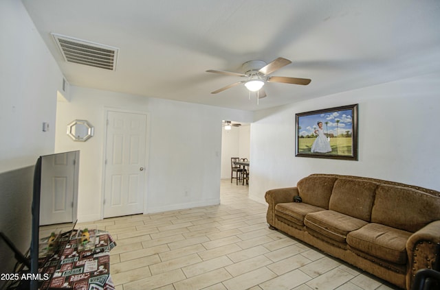 2022 W Atlanta Ave, Phoenix, AZ 85041 - living room featuring visible vents, baseboards, and a ceiling fan