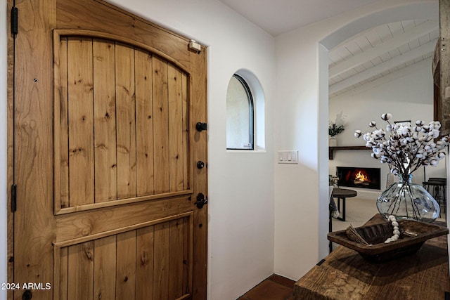 entrance foyer featuring beam ceiling and wood ceiling