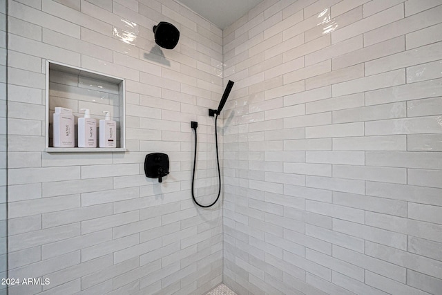 bathroom with tiled shower