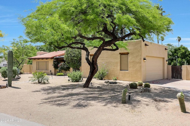 pueblo-style house with a garage