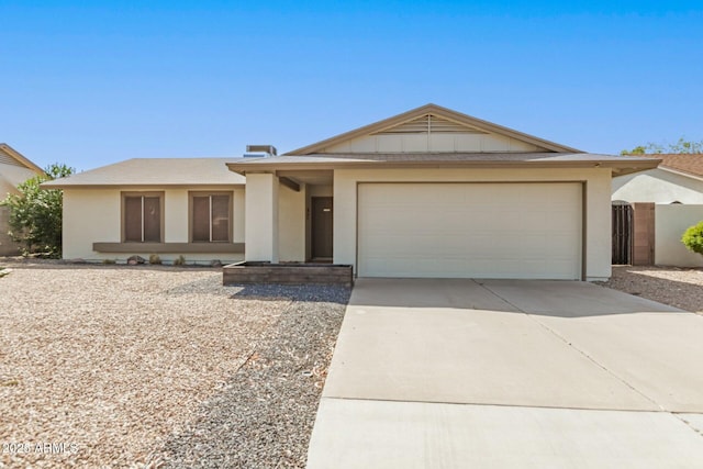 single story home with driveway, board and batten siding, and an attached garage