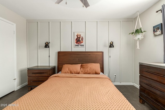 bedroom with dark tile patterned floors and ceiling fan