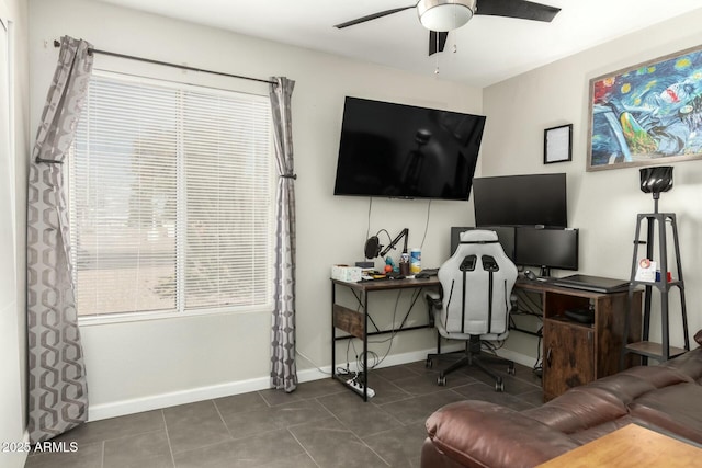 tiled office space with baseboards and ceiling fan