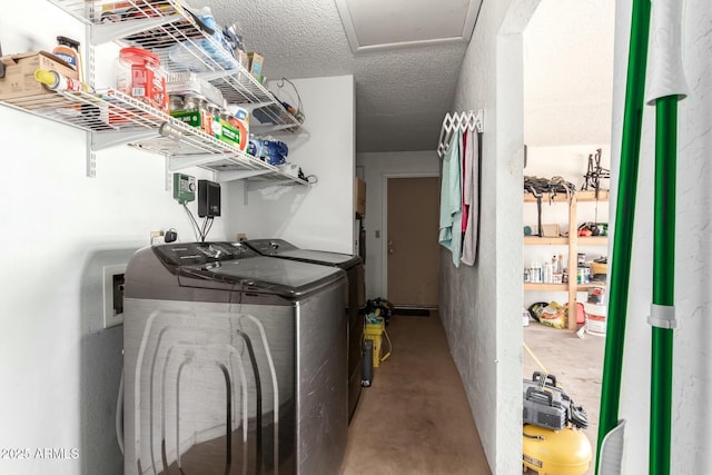 clothes washing area featuring laundry area, independent washer and dryer, and a textured ceiling