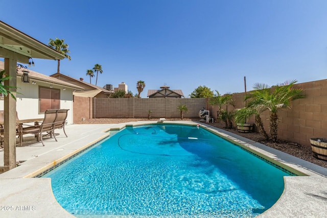 view of swimming pool featuring a patio area, a fenced in pool, and a fenced backyard