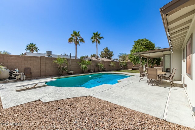 view of swimming pool with a diving board, a patio area, a fenced in pool, and a fenced backyard