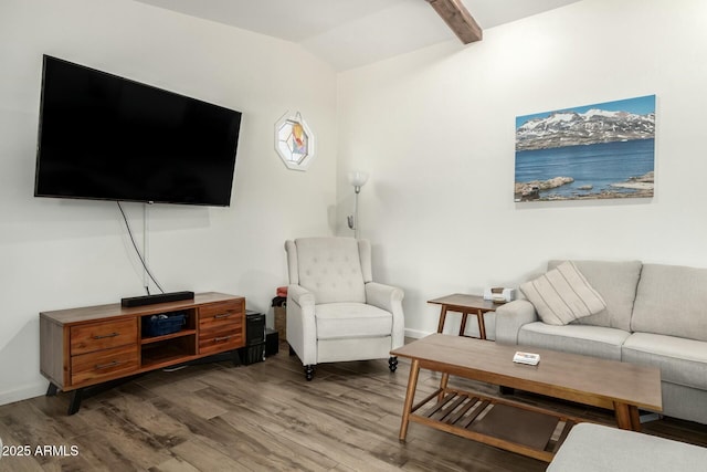 living area with vaulted ceiling, baseboards, and wood finished floors