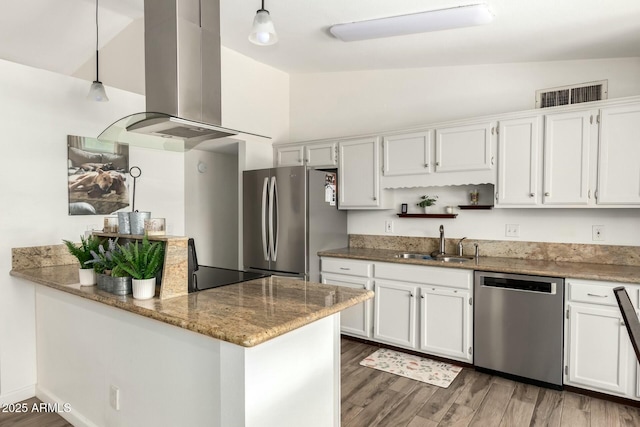 kitchen with a sink, stone countertops, appliances with stainless steel finishes, extractor fan, and vaulted ceiling