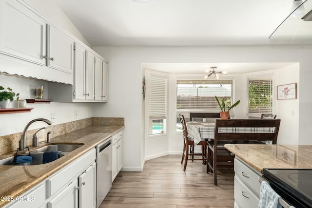 kitchen with light wood-style flooring, a sink, white cabinetry, light stone countertops, and dishwasher