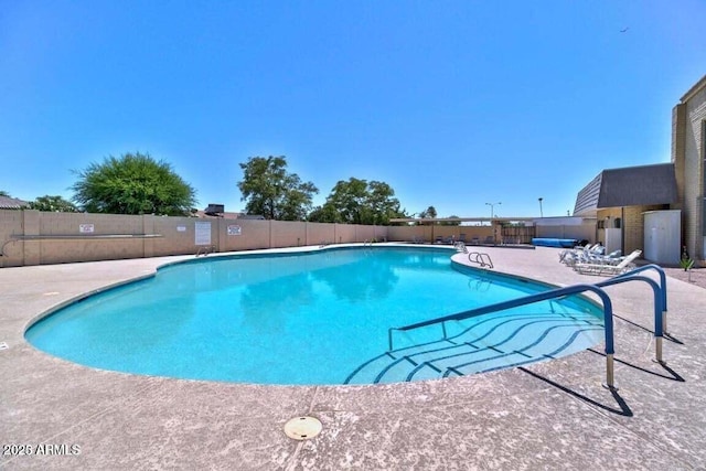 view of swimming pool with a patio area