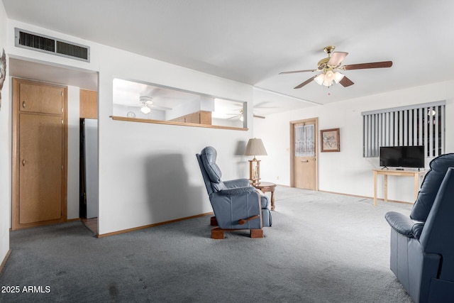 living area featuring carpet flooring and ceiling fan