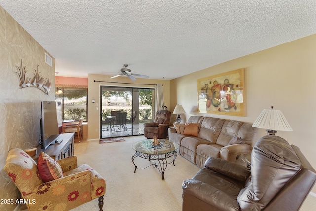 living room featuring ceiling fan and a textured ceiling