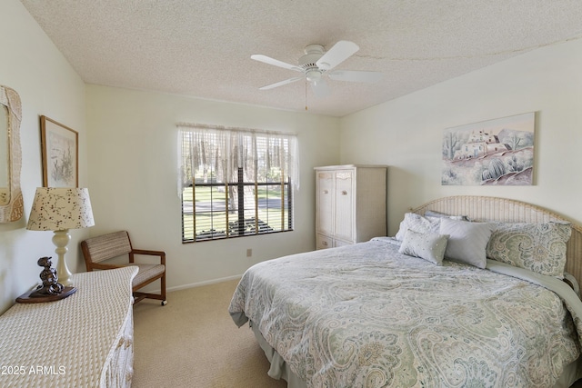 carpeted bedroom with a textured ceiling and ceiling fan