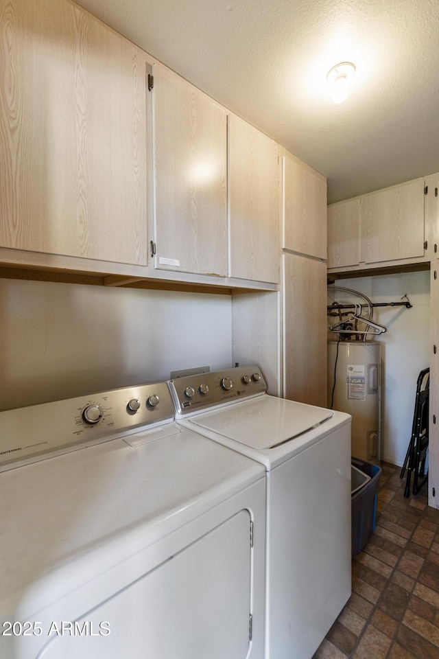 laundry area featuring cabinets, washer and clothes dryer, and electric water heater