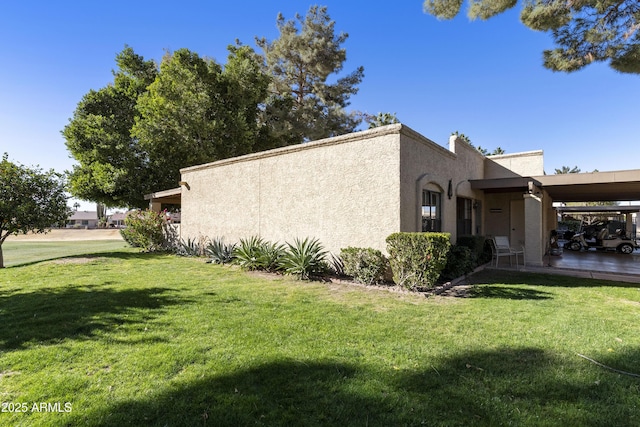 view of property exterior featuring a carport and a lawn