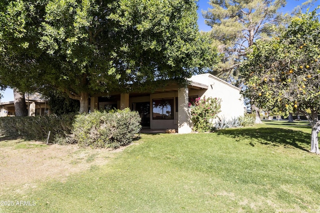 obstructed view of property with a front yard