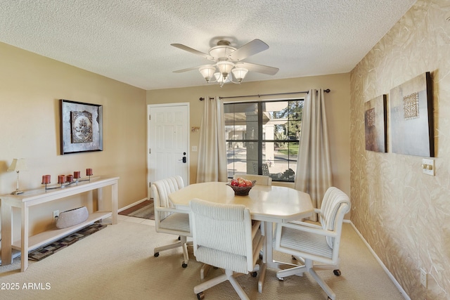 carpeted dining area featuring ceiling fan and a textured ceiling