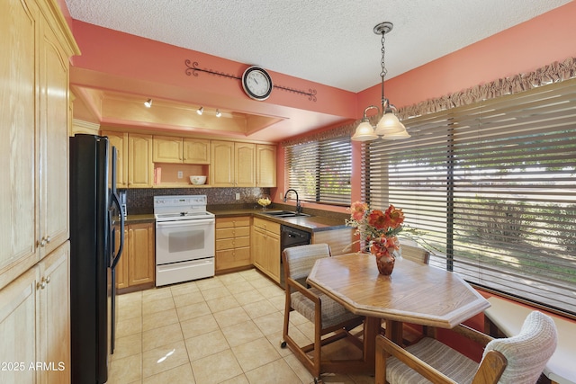 kitchen with sink, light tile patterned floors, a tray ceiling, pendant lighting, and black appliances