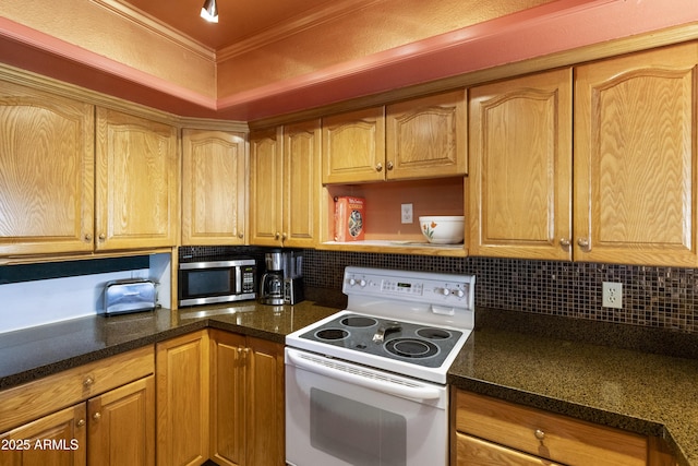 kitchen featuring tasteful backsplash, ornamental molding, dark stone countertops, and white electric range