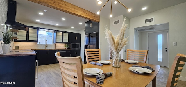 dining area with visible vents, light wood-style flooring, beam ceiling, and recessed lighting