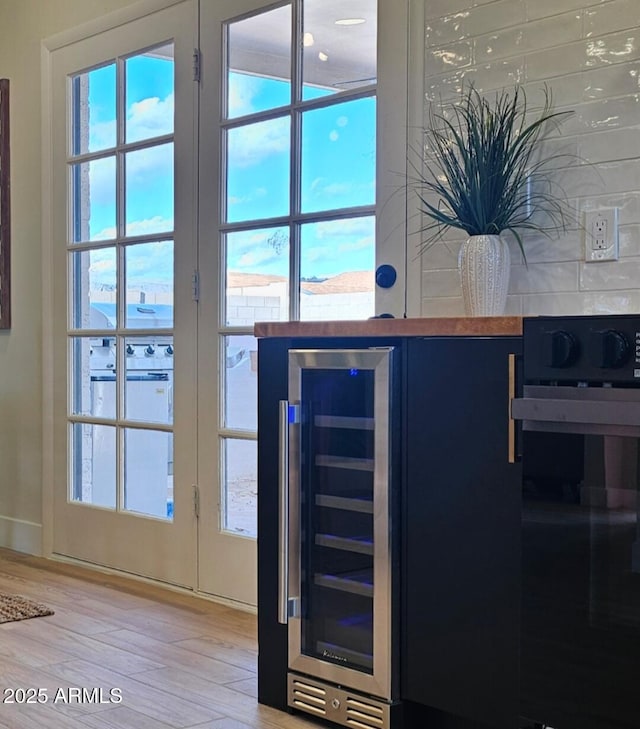 doorway featuring light wood-style flooring and beverage cooler