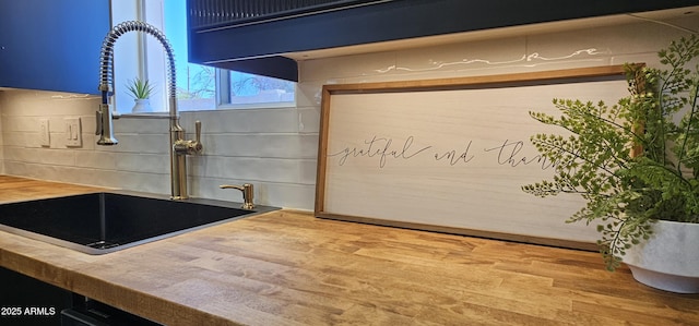 interior details with a sink and butcher block counters