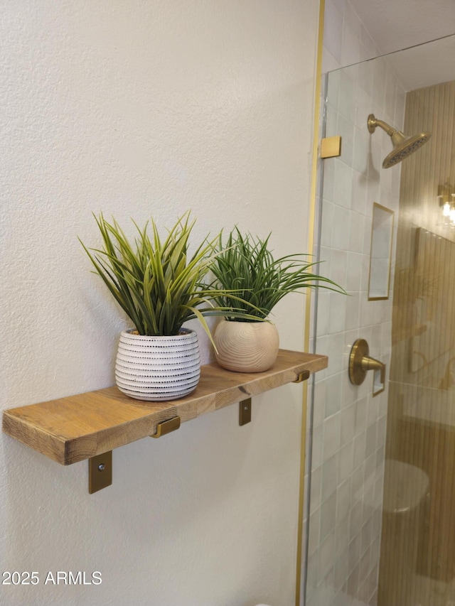 interior details featuring a stall shower