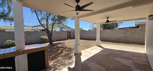 view of patio / terrace featuring a fenced backyard and a ceiling fan