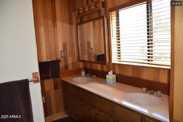 bathroom featuring vanity and wood walls