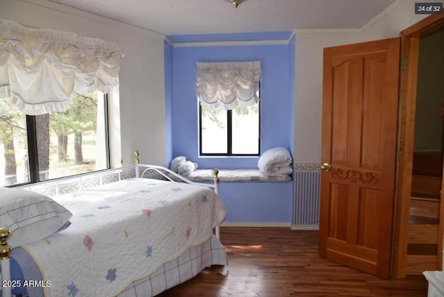 bedroom with crown molding, dark hardwood / wood-style flooring, and multiple windows